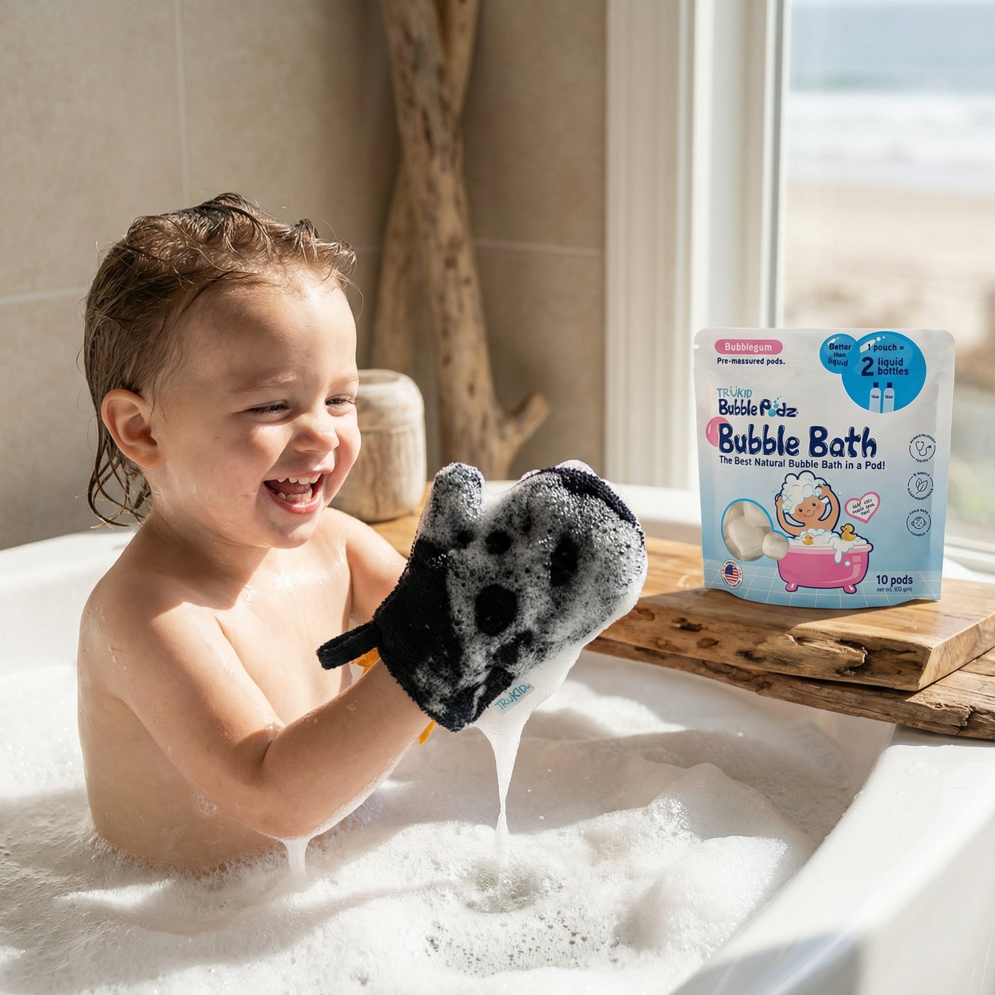 Child in a bathtub with a bubble glove and a package of bubble bath in the background.