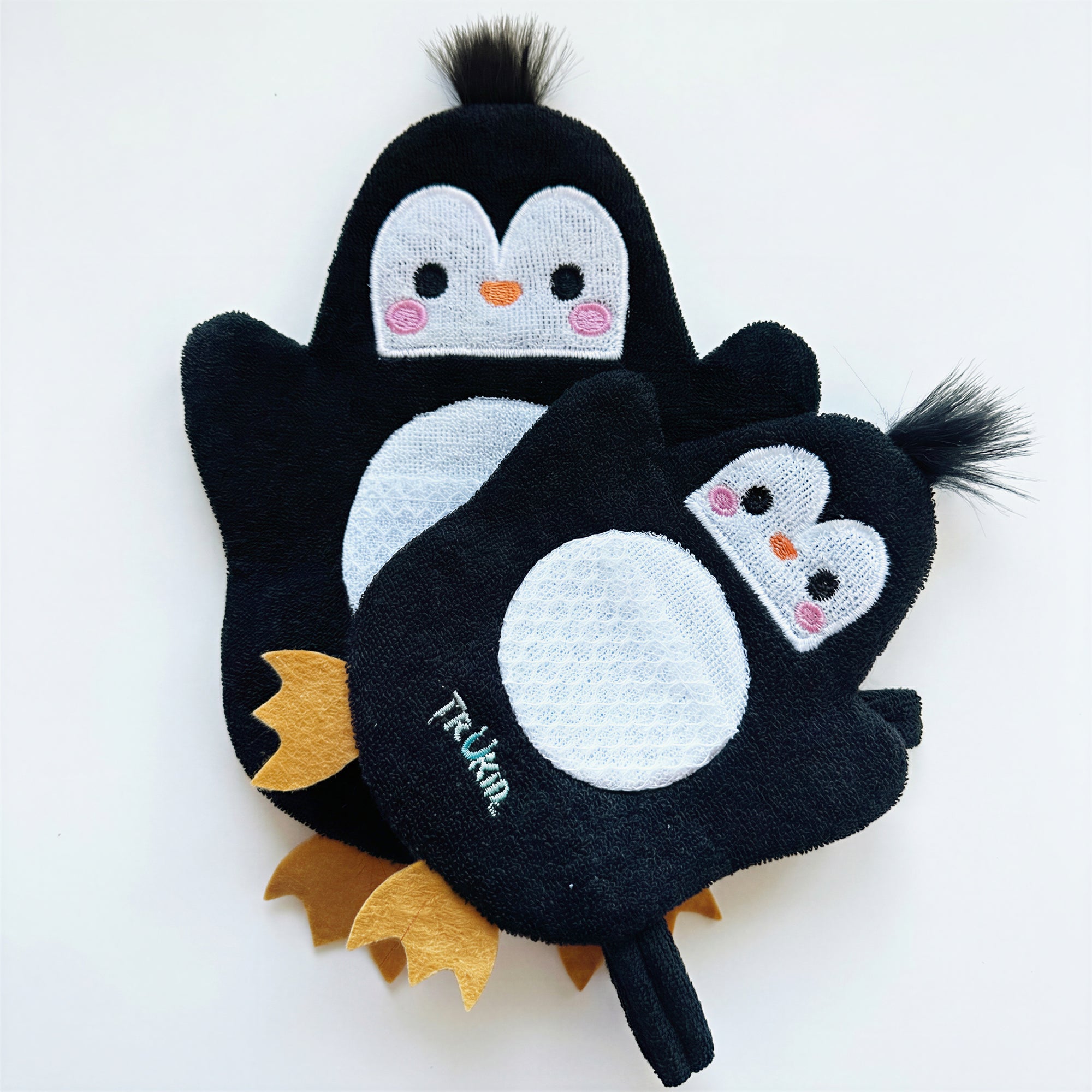 Two penguin shape bath gloves on a white background
